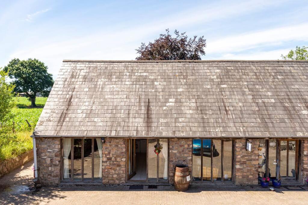 an old brick building with a bunch of windows at Self-Catering at Craft Renaissance in Usk