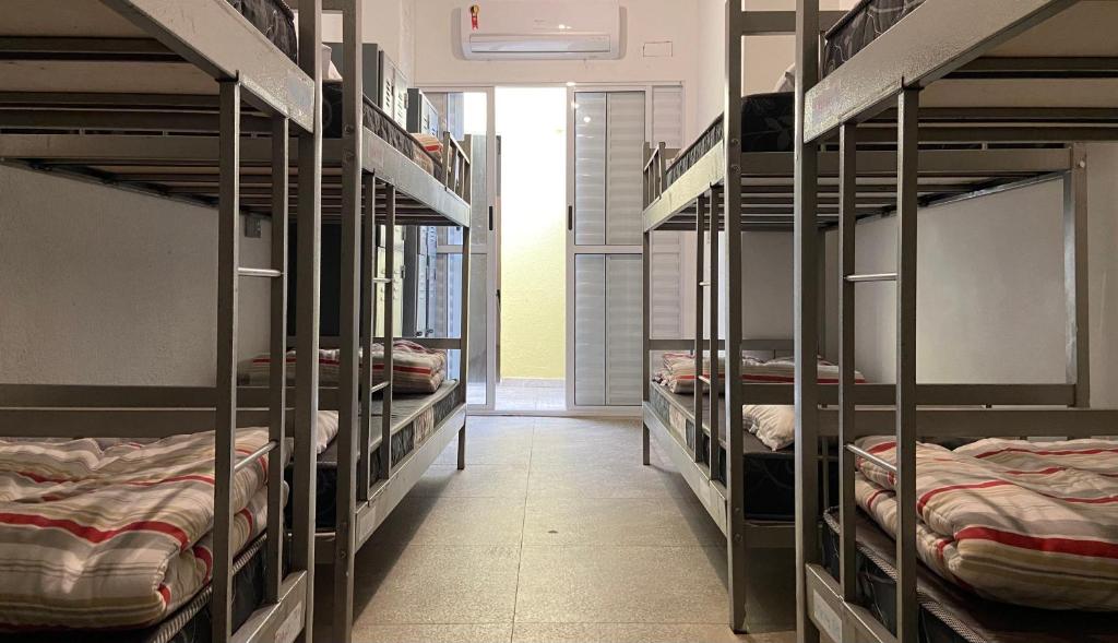 a room with several bunk beds in a room at Imagina Hostel in Sao Paulo