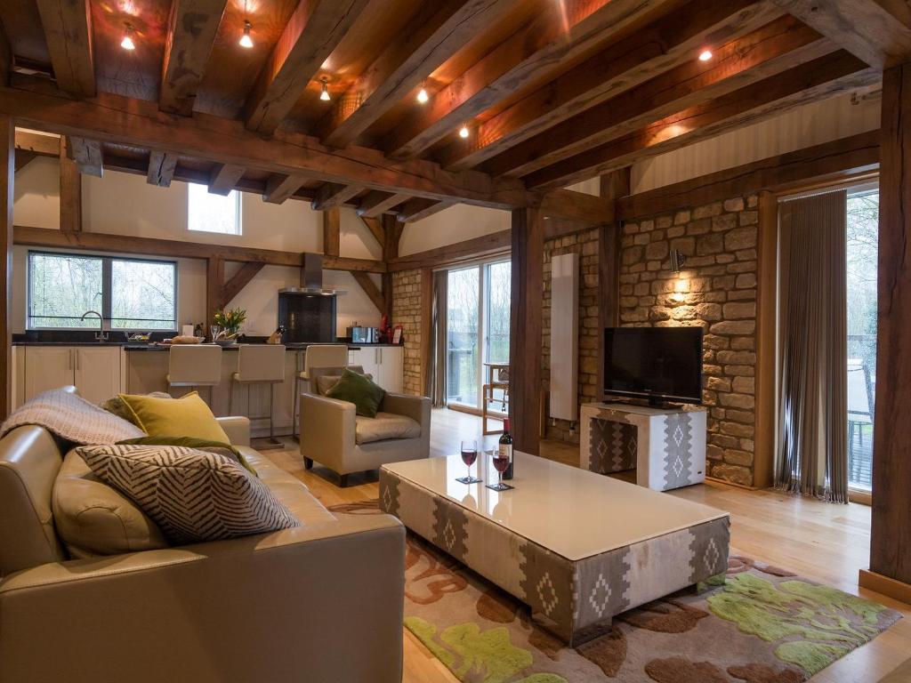 a living room with a couch and a coffee table at Coot Lodge in Somerford Keynes