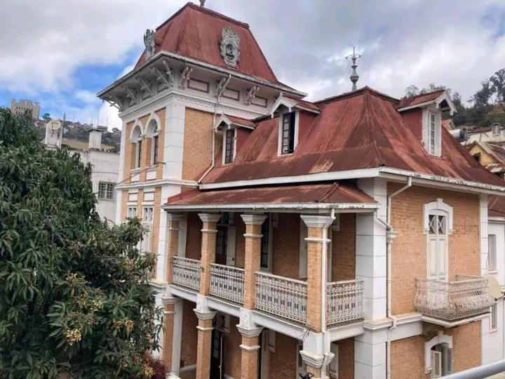 a building with a clock tower on top of it at Le Manoir in Antananarivo