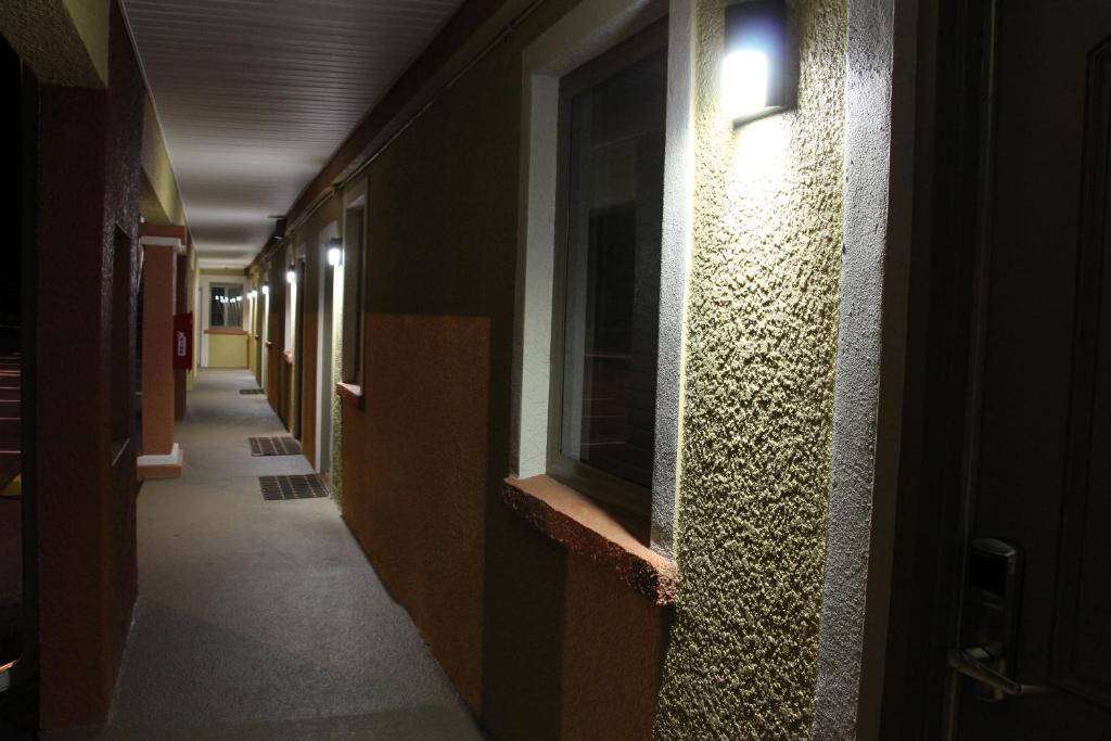 a hallway of a building with a light on the wall at Budget Inn Lake Wales in Lake Wales
