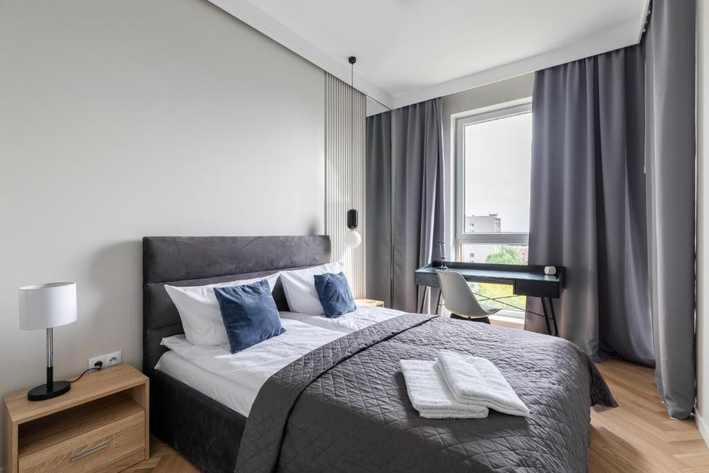 Posteľ alebo postele v izbe v ubytovaní P&O Apartments Rydygiera II