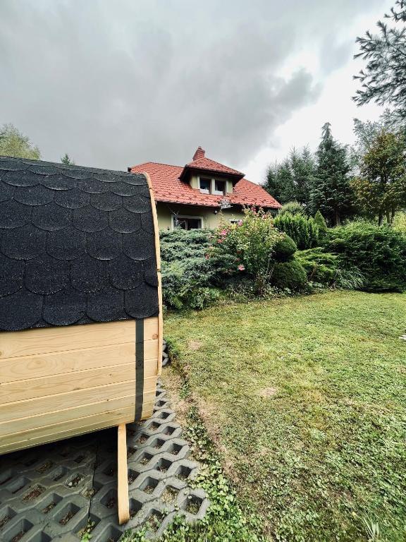 a house with a roof on top of a yard at Zielony Dom in Węglówka