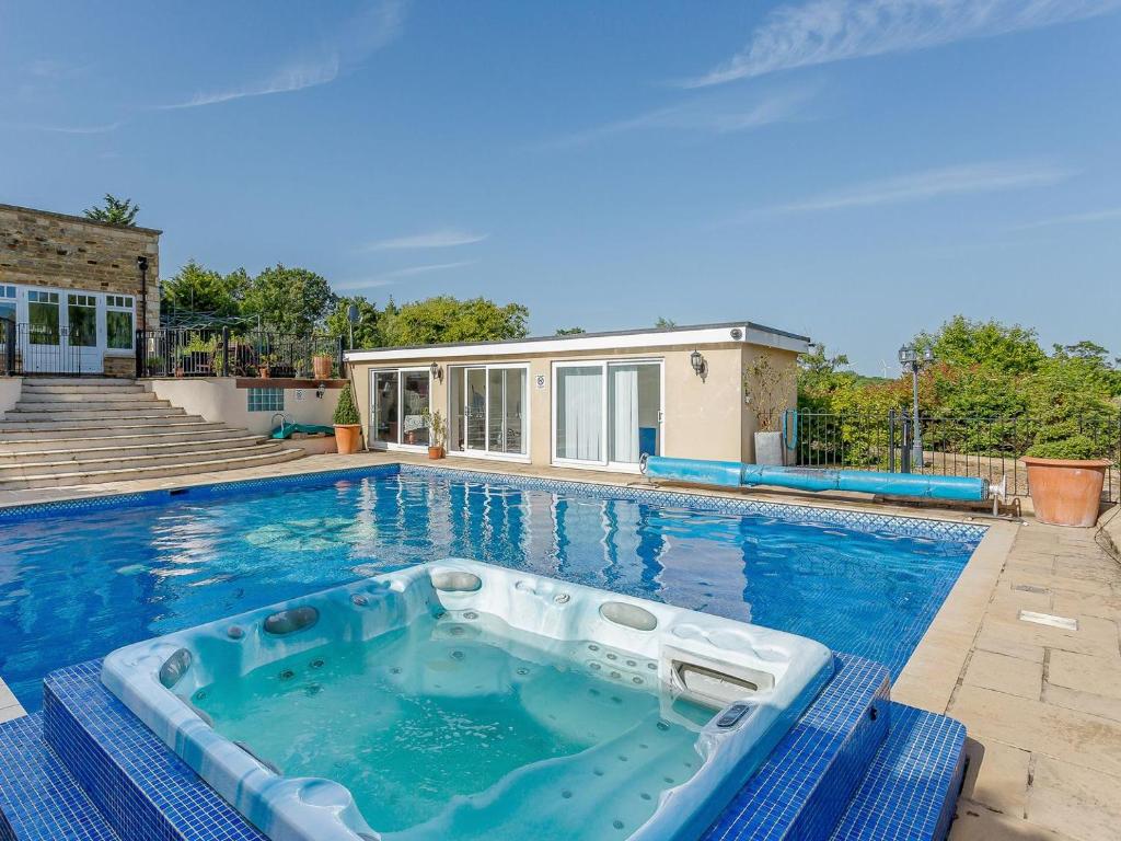 a swimming pool with a tub in the middle of a house at Allerton House in Isham