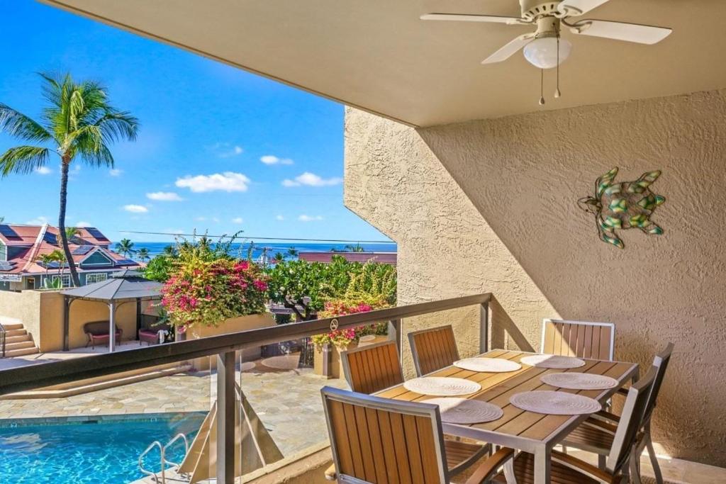 a dining room with a table and a view of the ocean at Kona Pacific A206 Condo in Kailua-Kona