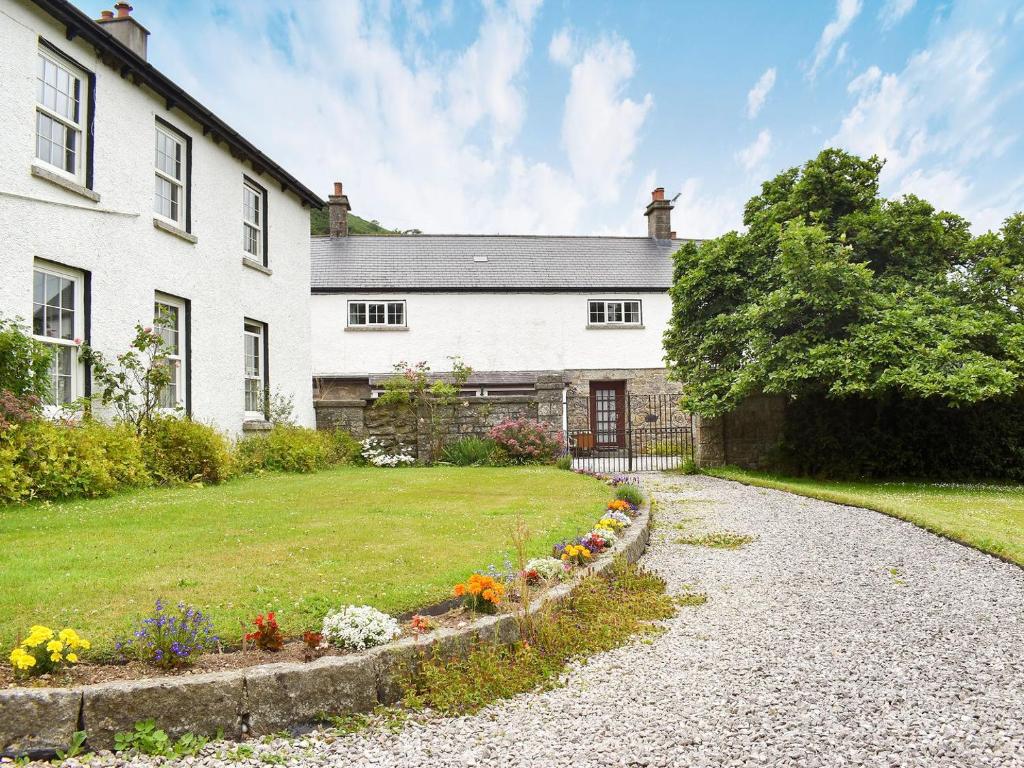 a white house with a garden and a driveway at Lower Chinkwell-uk12426 in Widecombe in the Moor