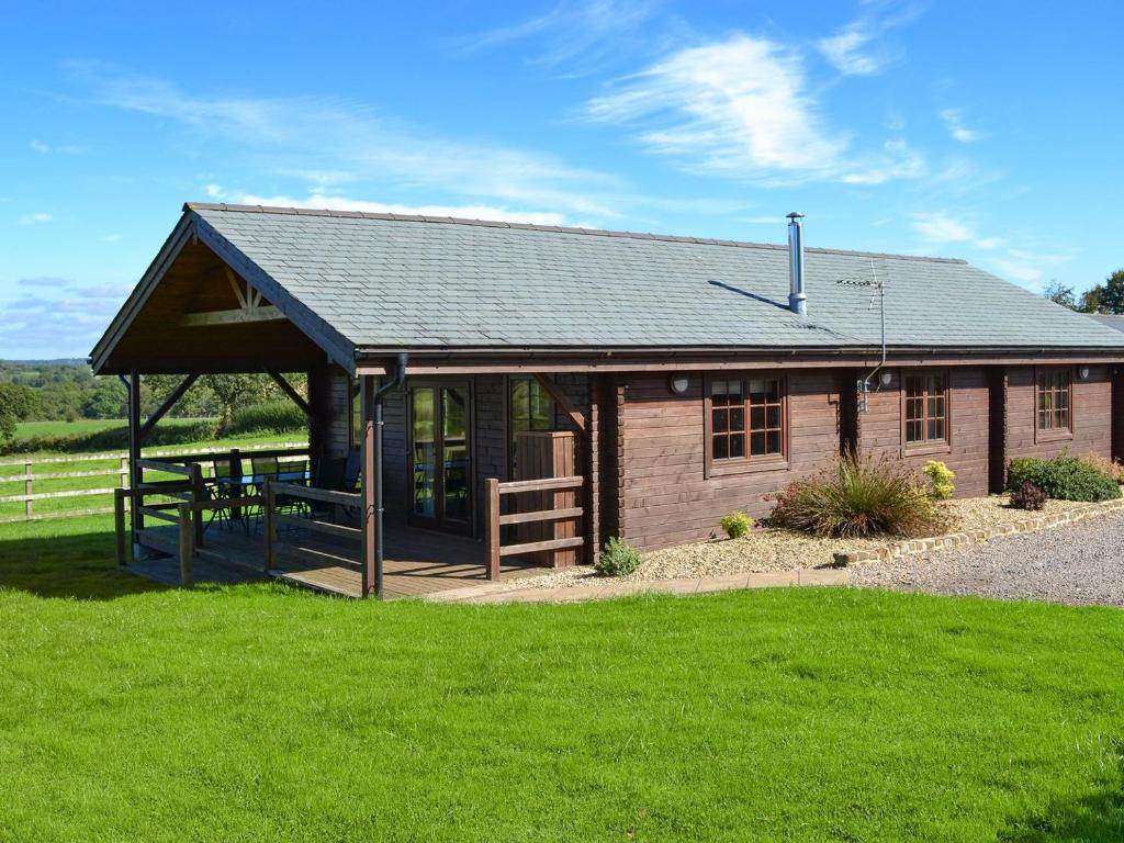 a small cabin with a picnic table in front of it at Exmoor - Uk12539 in Witheridge