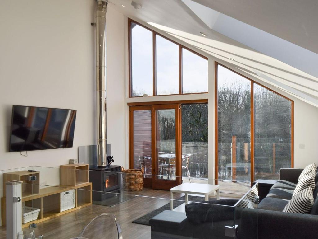 a living room with a couch and a tv at Waterside Lodge Sixteen - Uk13038 in Southowram