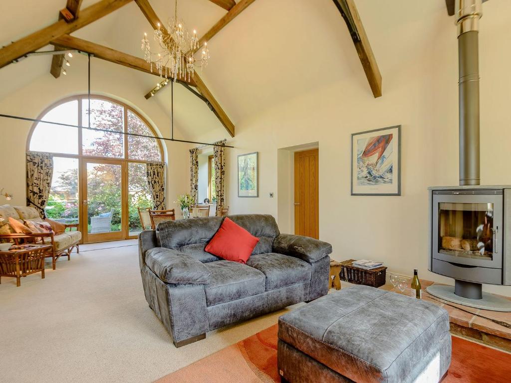 a living room with a couch and a fireplace at Courtyard Lodge in Edwinstowe