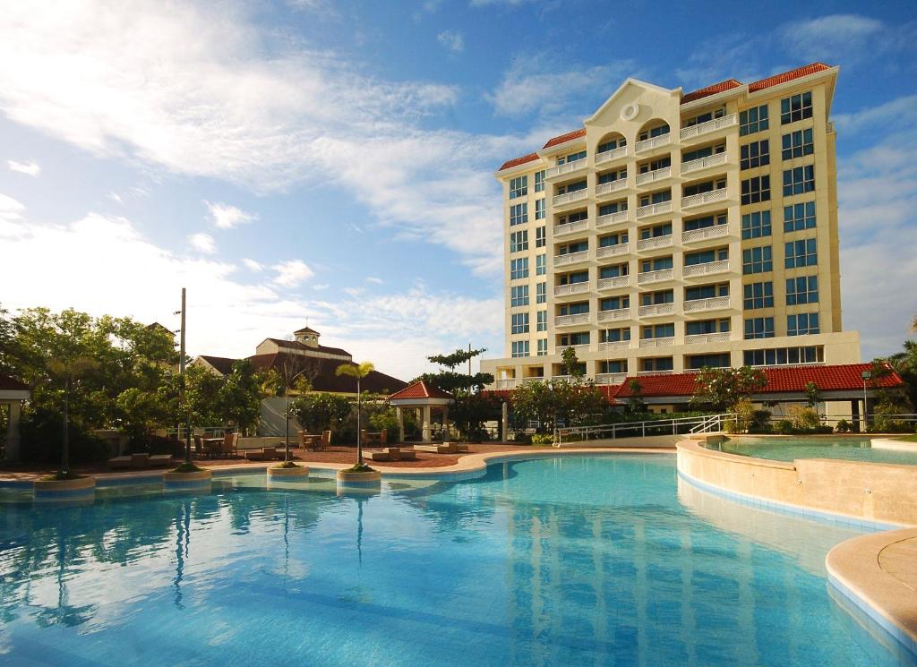 a large swimming pool in front of a hotel at Sotogrande Hotel and Resort in Mactan