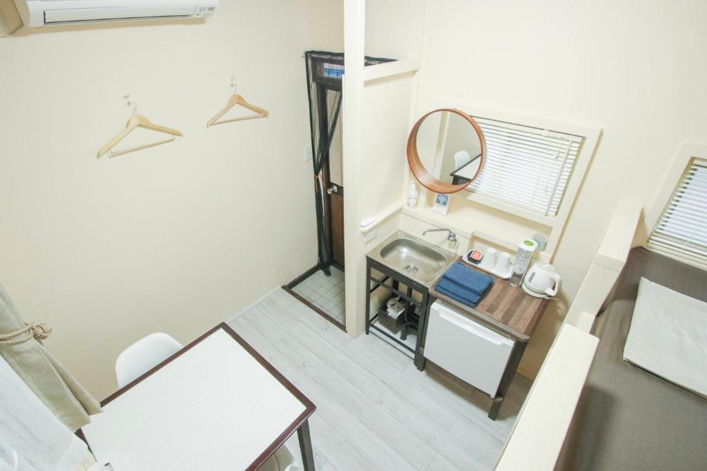 Postel nebo postele na pokoji v ubytování House Hotel Amami Minpaku Mura & Sauna