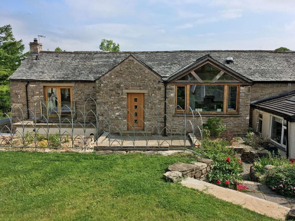 a stone house with a garden in front of it at Cumberland House in Orton