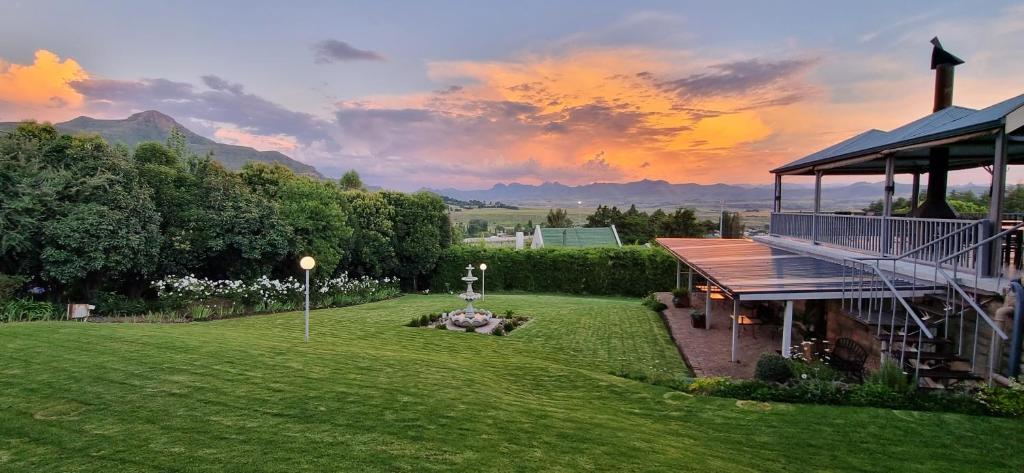 a large yard with a building and a field of grass at Ash River Lodge in Clarens