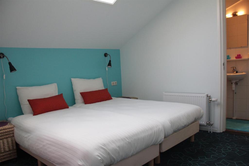 Een bed of bedden in een kamer bij Dorpslogement Pieterburen