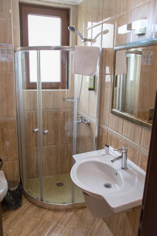 a bathroom with a glass shower and a sink at Paraiso Theopolis - All Inclusive in Obzor