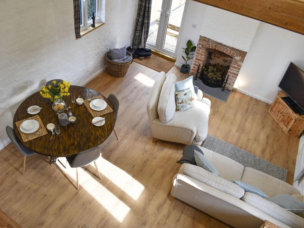 an overhead view of a living room with a table and chairs at The Hay Barn in Barnby