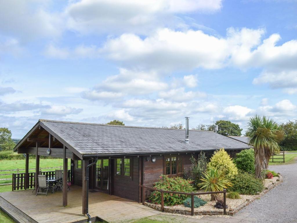 a small house with a deck in a field at Otter - Uk12540 in Witheridge