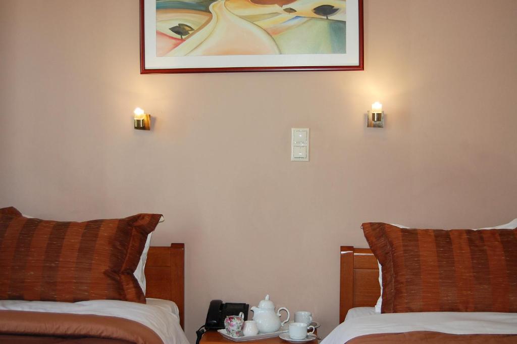 Postel nebo postele na pokoji v ubytování Paris Hotel