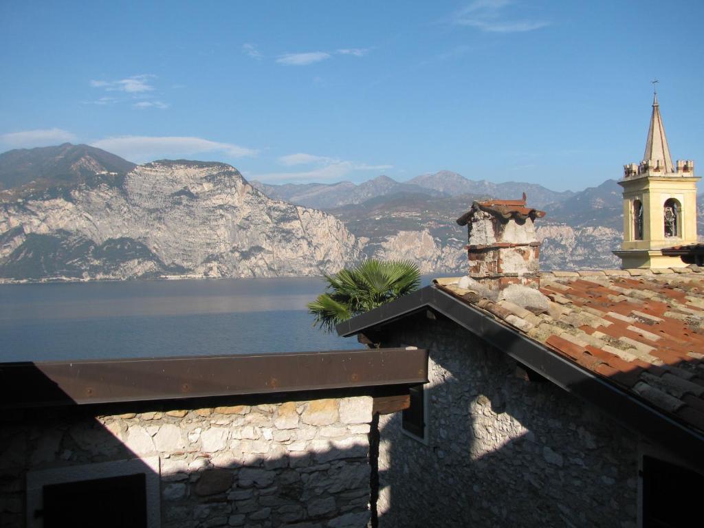 a building with a view of the water and mountains at Cà Del Polsèt in Brenzone sul Garda
