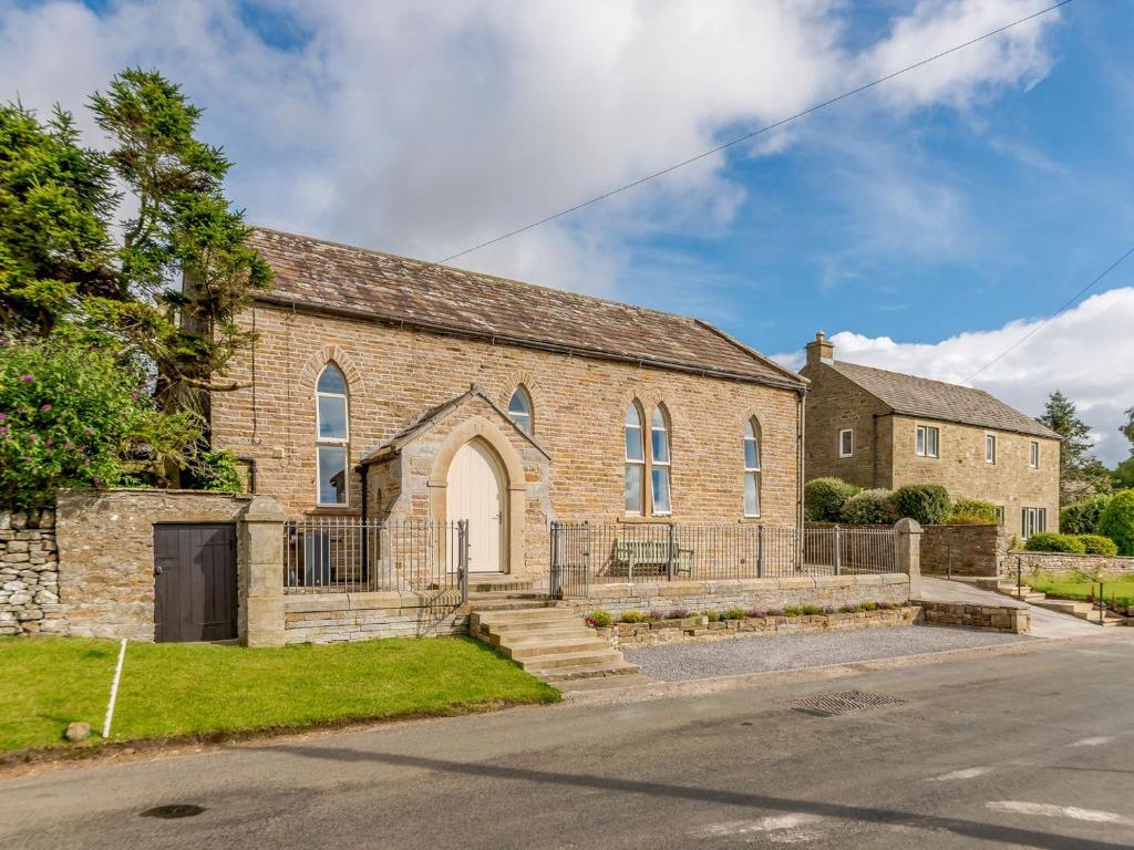 an old brick church with a driveway at Church Manor in Carlton