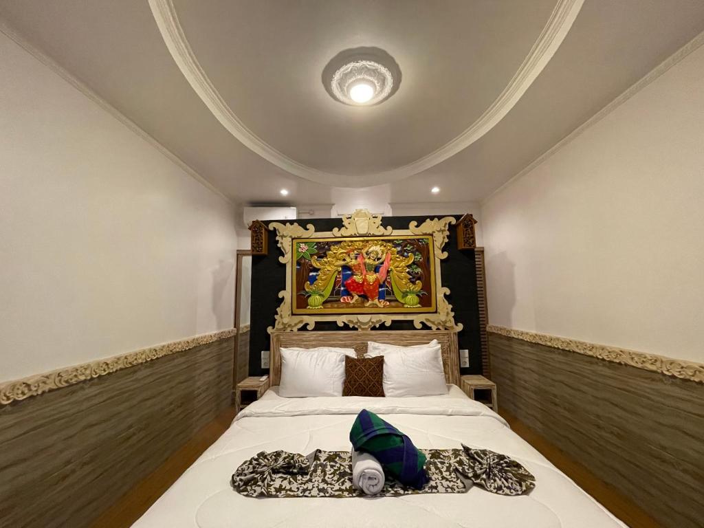 Кровать или кровати в номере Mikuk Cottages Canggu