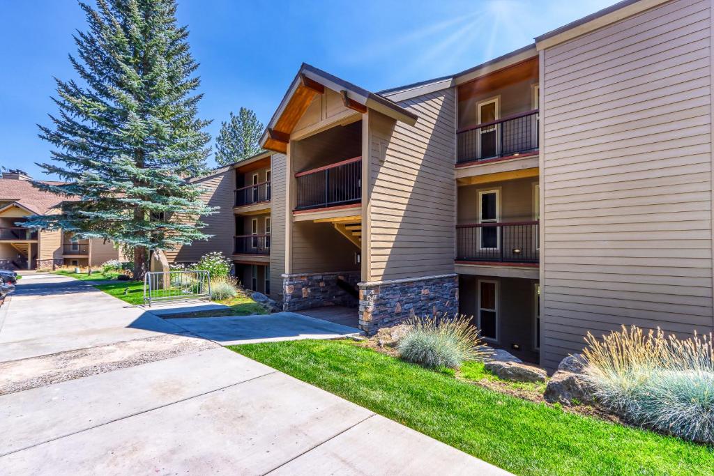 a apartment building with a pathway in front of it at Tree Top Retreat in Bend