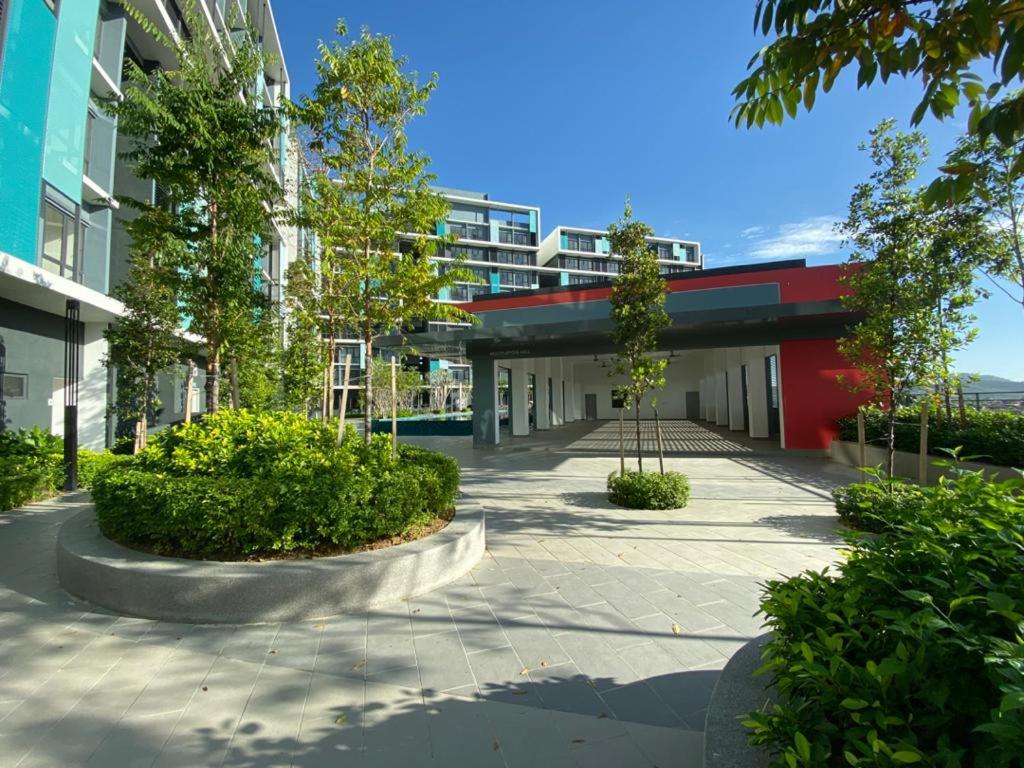 an empty courtyard of a building with trees and bushes at Airport KLIA Guest House (1 bedroom & 1 toilet) in Sepang