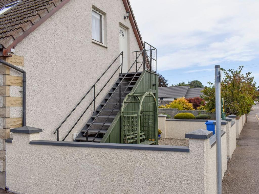 un conjunto de escaleras en el lateral de un edificio en Kimberley Apartment, en Alness