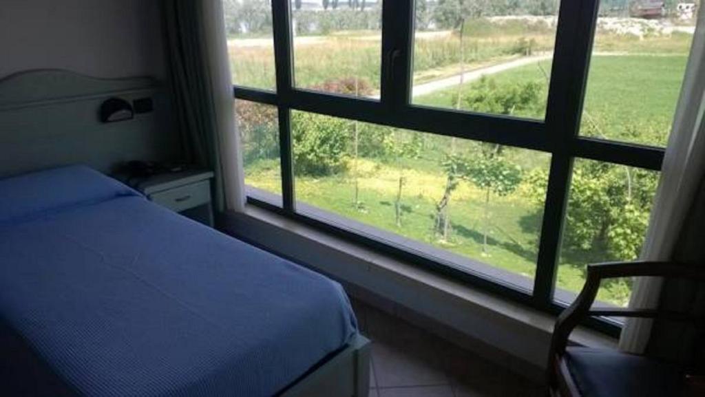 Postel nebo postele na pokoji v ubytování Albergo del Po