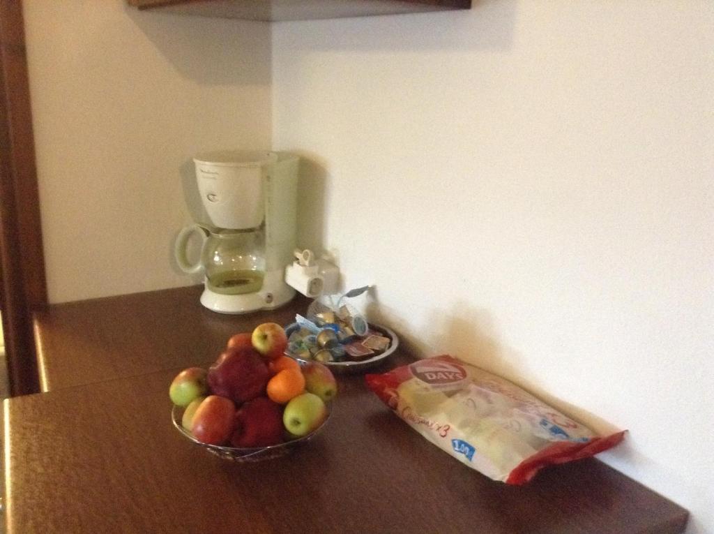a bowl of fruit on a counter next to a bag of cheese at Archontiko Ouranias in Makrinitsa