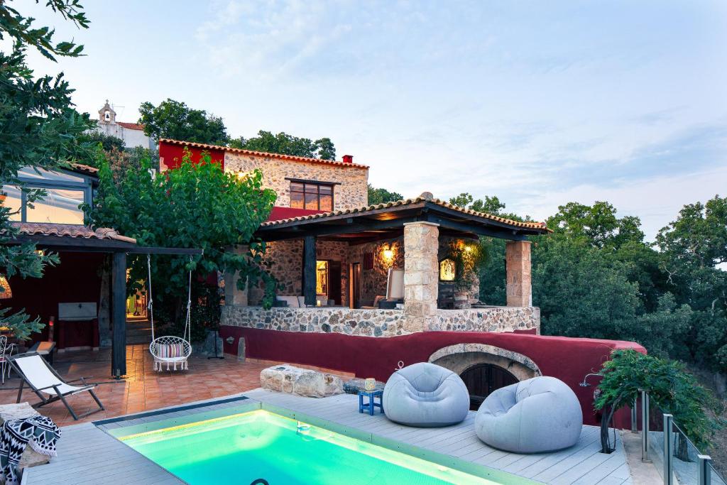 a home with a swimming pool and a house at Art Villa Kastellos in Kástellos