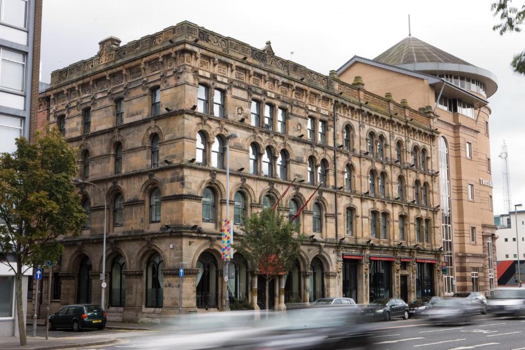 an old building on the corner of a city street at Malmaison Belfast in Belfast