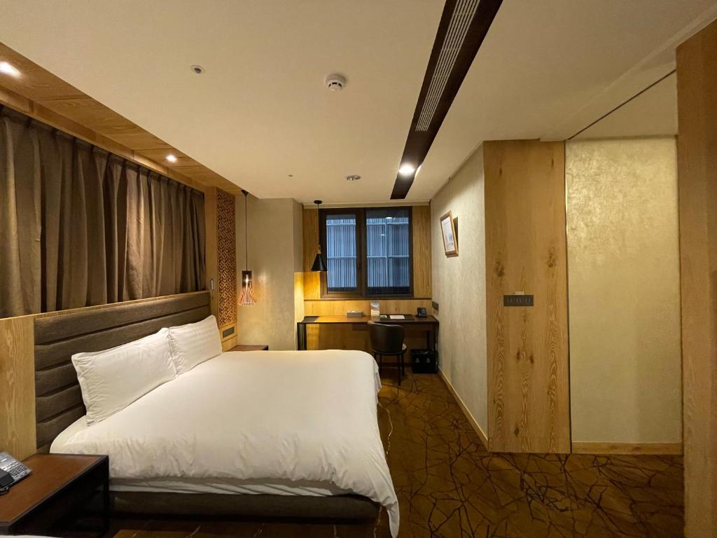 Postel nebo postele na pokoji v ubytování Hotel Château Anping
