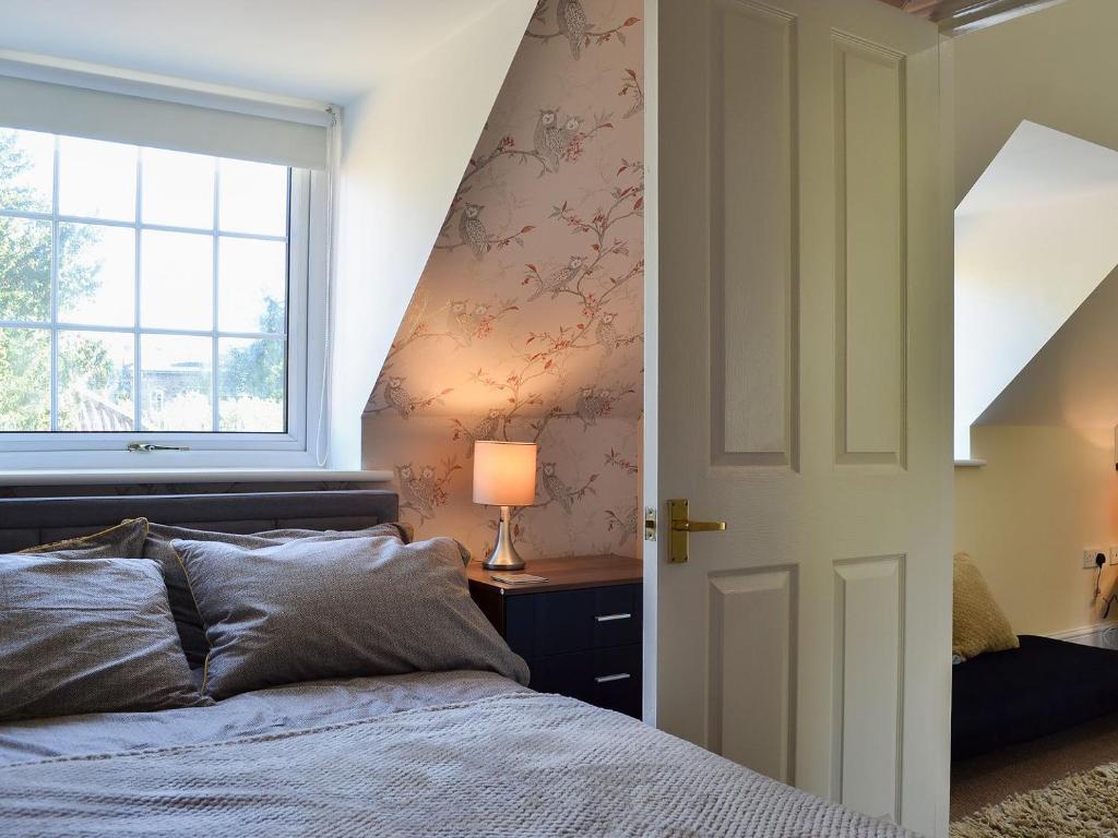 a bedroom with a bed and a window at The Nest in York