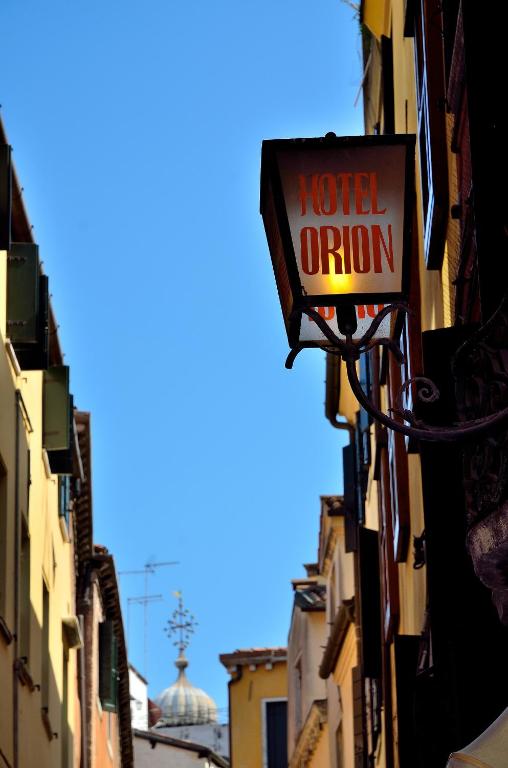 a sign on the side of a building that reads motel opinion at Hotel Orion in Venice