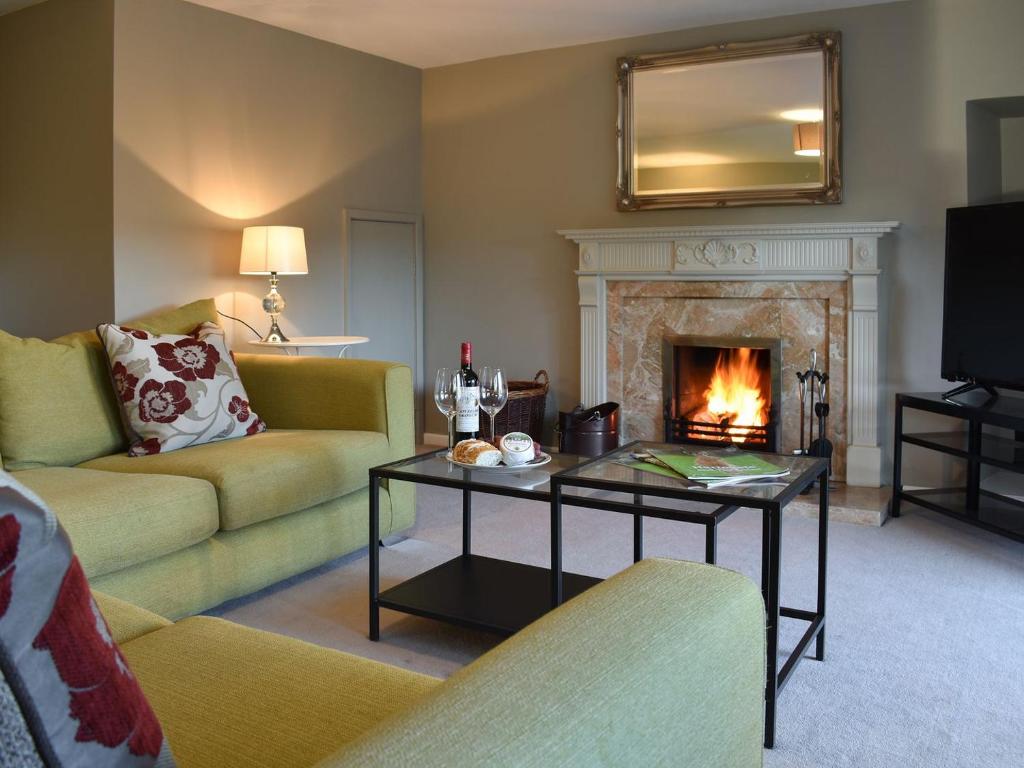 a living room with a couch and a fireplace at Thistle Cottage in Carlton