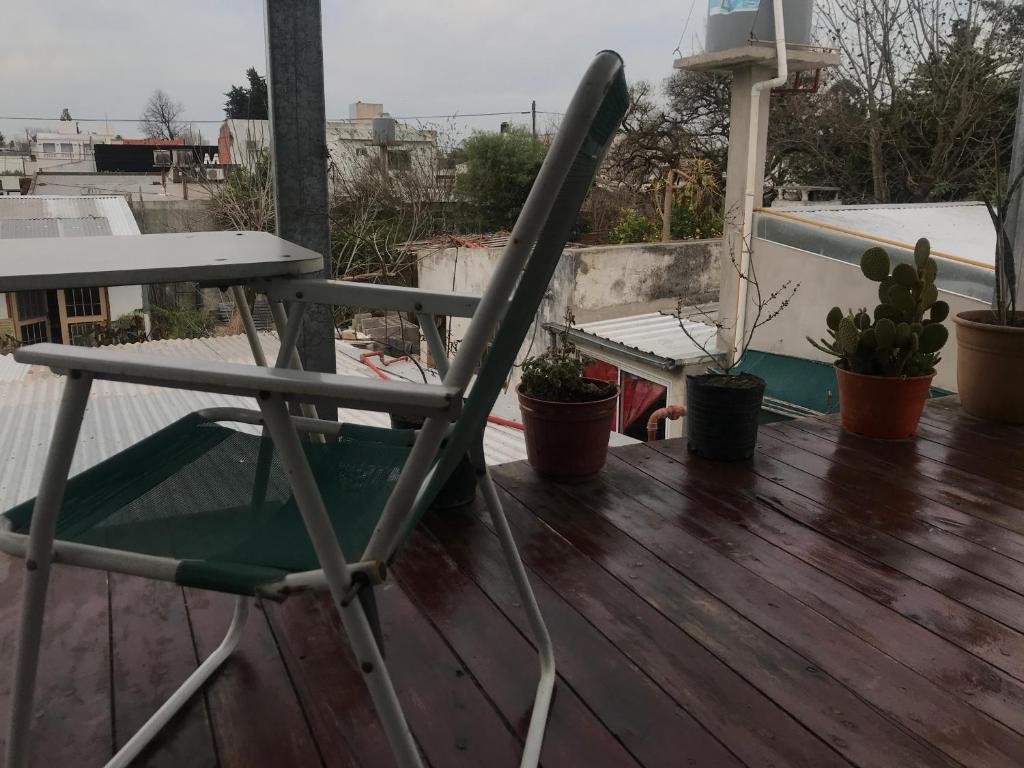 a chair sitting on top of a deck at Departamento tranquilo in Gualeguaychú