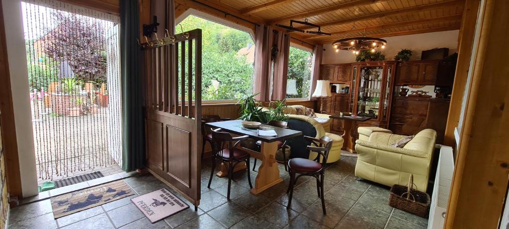 a living room with a table and chairs in a room at Auf dem Reiterhof in Wernigerode