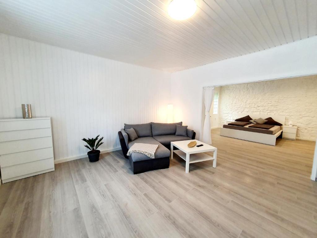 a living room with a couch and a bed at Ferienwohnung in Gersheim / bis 4 Personen in Gersheim