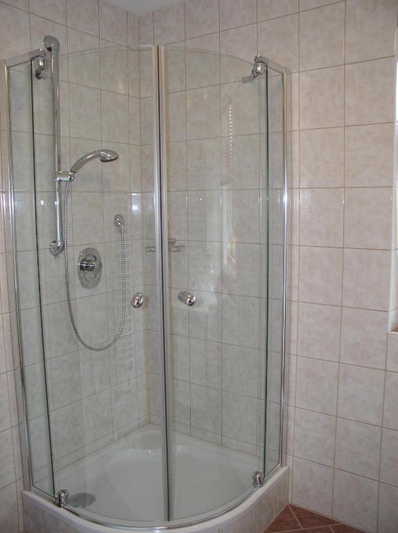 a shower with a glass door in a bathroom at Haus Waldfriede in Pertisau