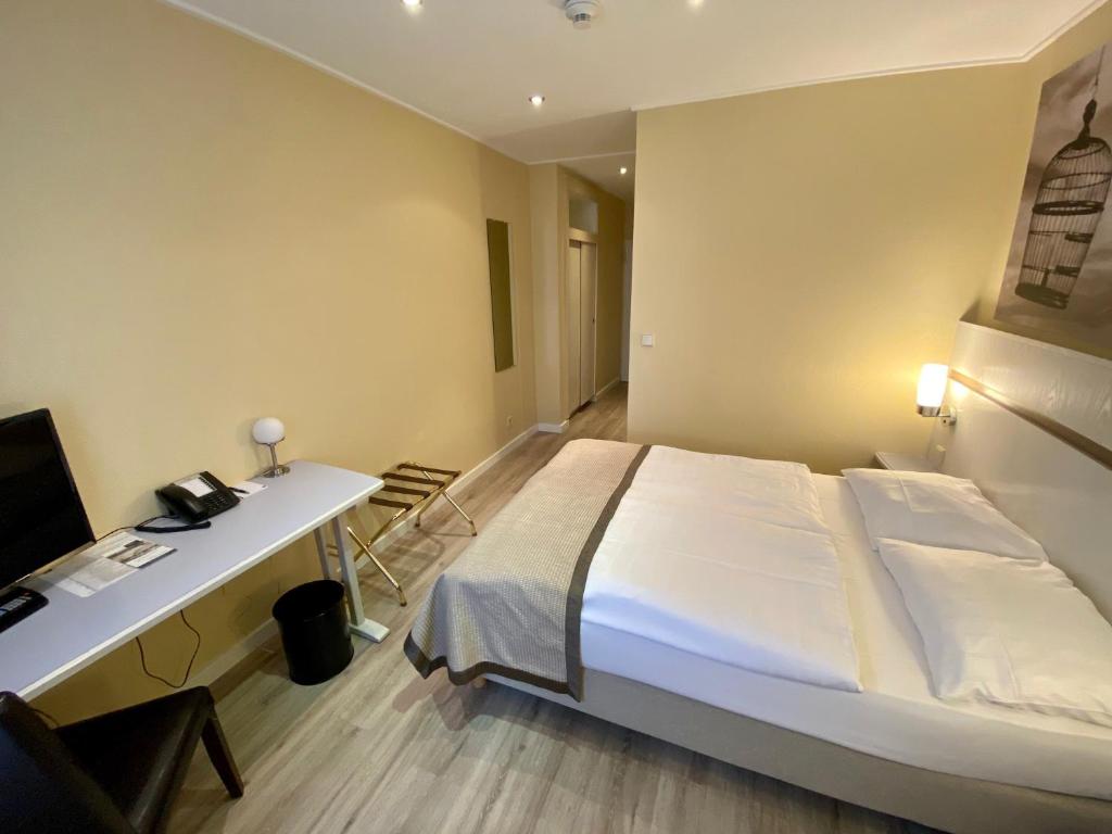 Postel nebo postele na pokoji v ubytování Park Hotel Hamburg Arena