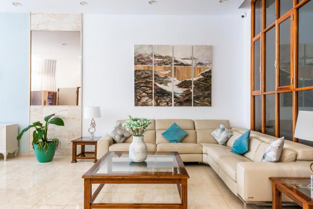 a living room with a couch and a table at Hotel Andrea´s in Los Cristianos