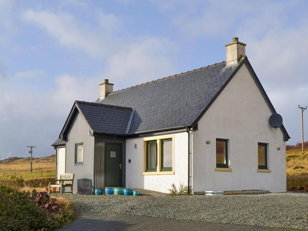 a white house with a black roof at Taigh Iasg-uk30003 in Kingsburgh