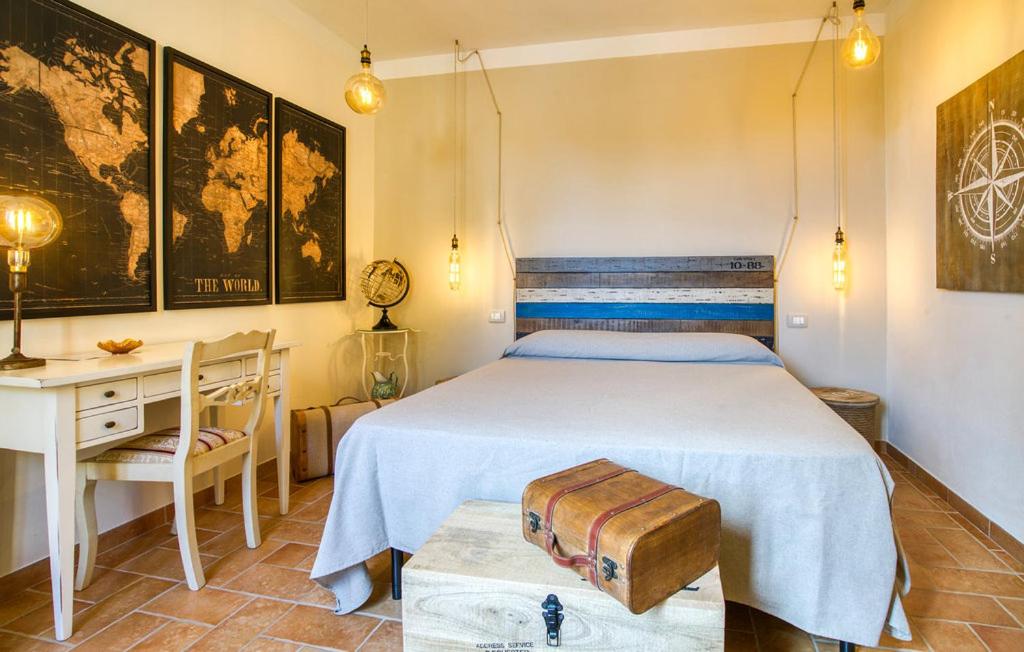 a bedroom with a bed and a desk and a desk at Casa Maria - Dimora di Charme in Montalcino