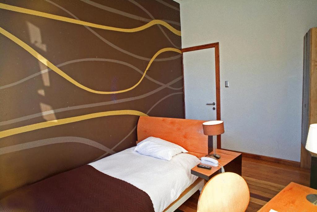 Postel nebo postele na pokoji v ubytování Hotel Latitud 33º Sur