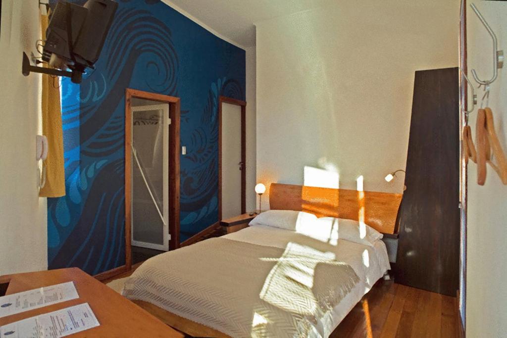 Postel nebo postele na pokoji v ubytování Hotel Latitud 33º Sur