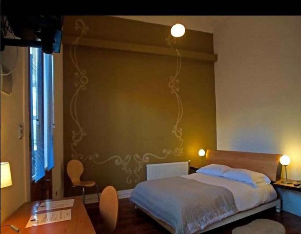 Postel nebo postele na pokoji v ubytování Hotel Latitud 33º Sur