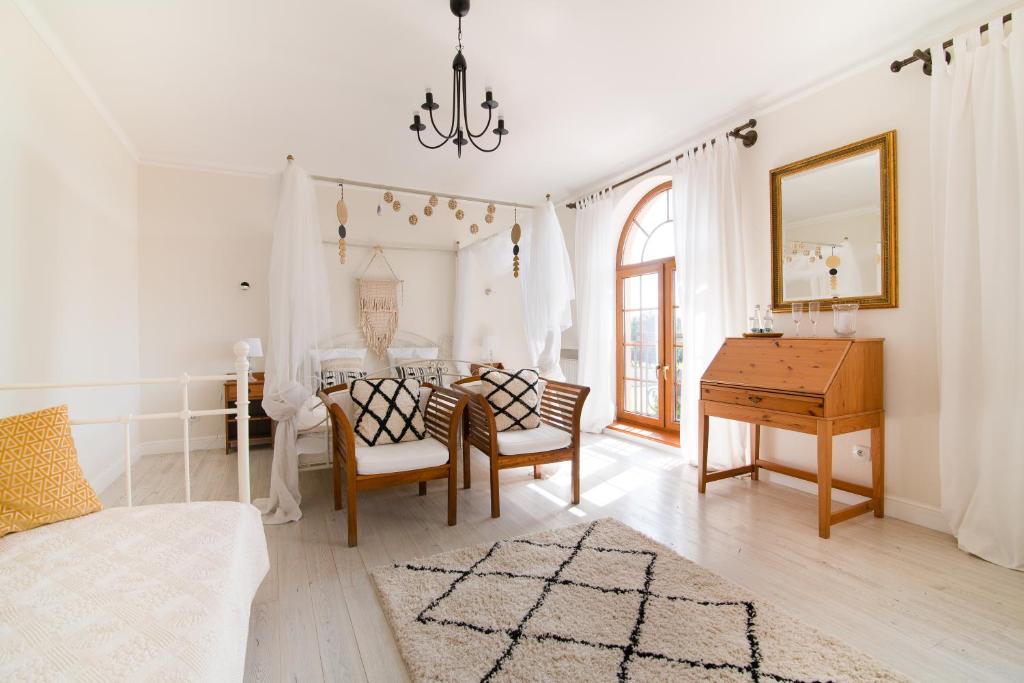 a living room with a table and a desk at HOTEL LEMONIADA in Lućmierz