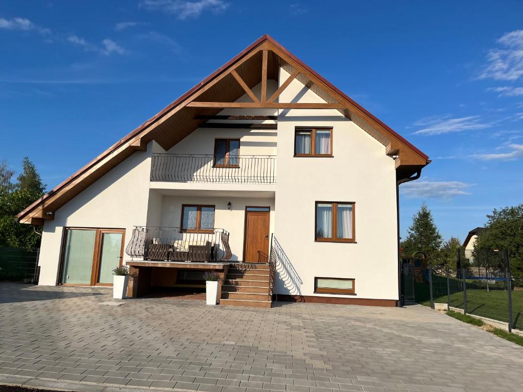 a large white house with a gambrel roof at Chata Javor in Kežmarok