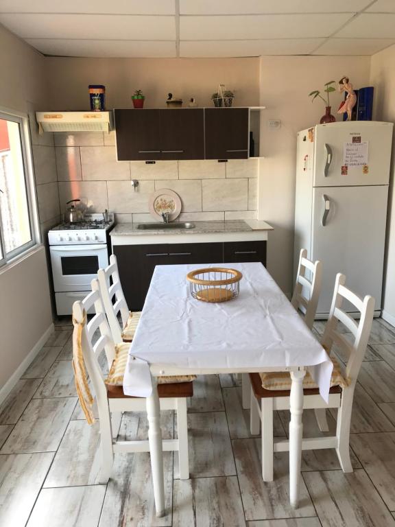 a kitchen with a table and chairs and a refrigerator at Departamento en Olavarría in Olavarría